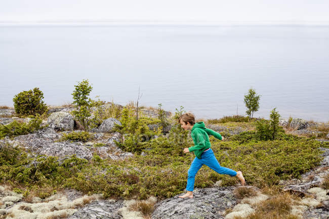 Boy running by sea, selective focus — Stock Photo