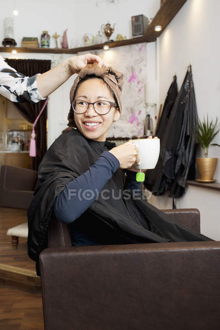 Hairdresser drying customers hair, selective focus — Stock Photo