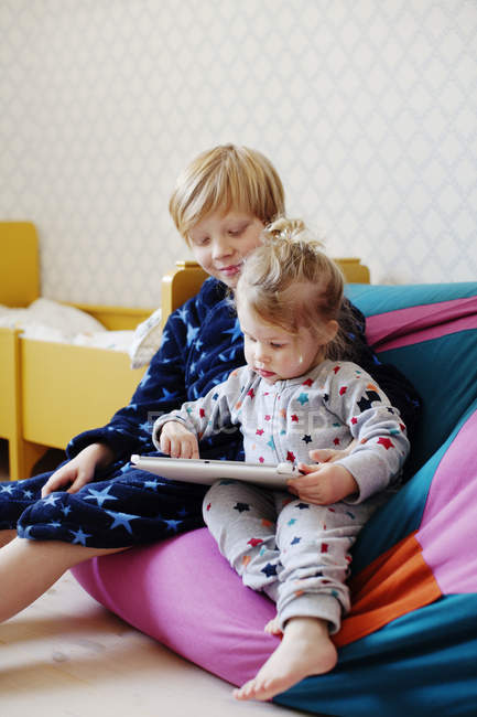 Menino e menina usando tablet digital, foco diferencial — Fotografia de Stock