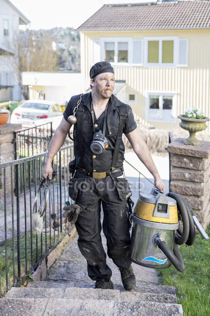 Chimney sweep with vacuum cleaner, selective focus — Stock Photo