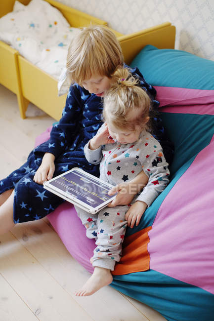 Menino e menina usando tablet digital, foco diferencial — Fotografia de Stock