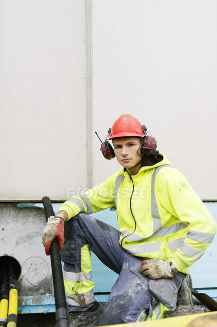 Portrait of construction worker holding pipe — Stock Photo