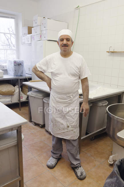 Portrait of chef looking at camera in commercial kitchen — Stock Photo