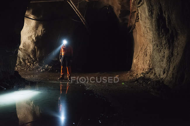 Miner in protective workwear working underground — Stock Photo