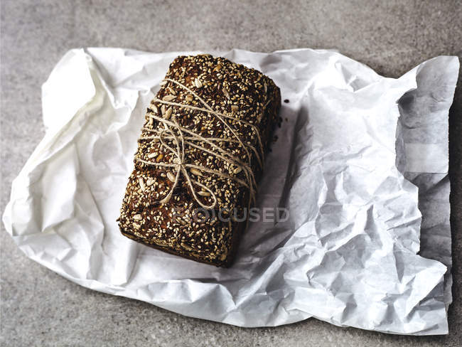 Elevated view of loaf of bread on paper bag — Stock Photo