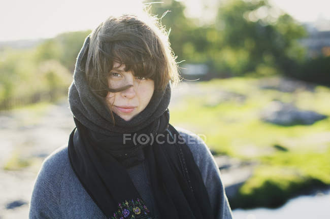 Portrait of young woman with scarf around head — Stock Photo