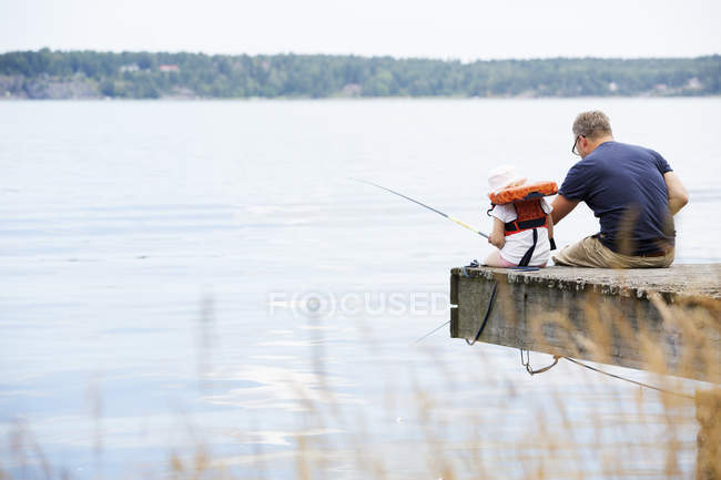 Отец и дочь рыбачат на шведском архипелаге — стоковое фото