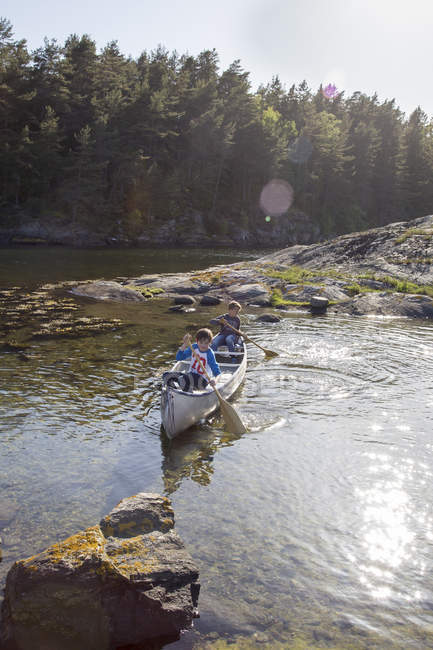Boys canoeing on river at summer, selective focus — Stock Photo