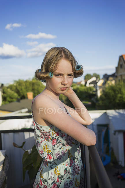 Young girl with curlers in hair, focus on foreground — Stock Photo