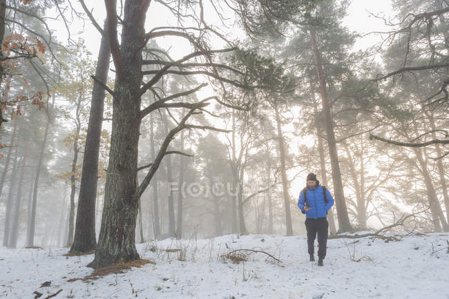 Man walking through snowy forest, selective focus — Stock Photo