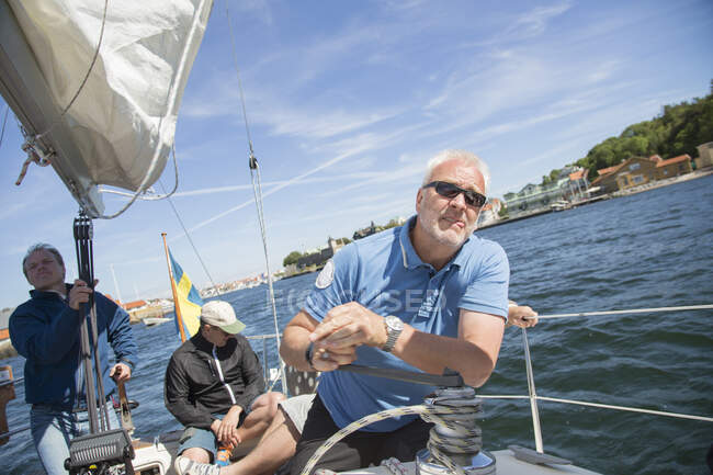 Mature men sailing on yacht at sea — Stock Photo