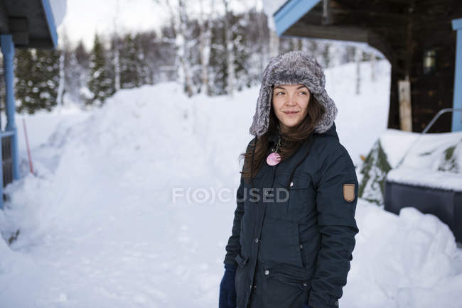 Young woman wearing parka and fur hat in winter — Stock Photo