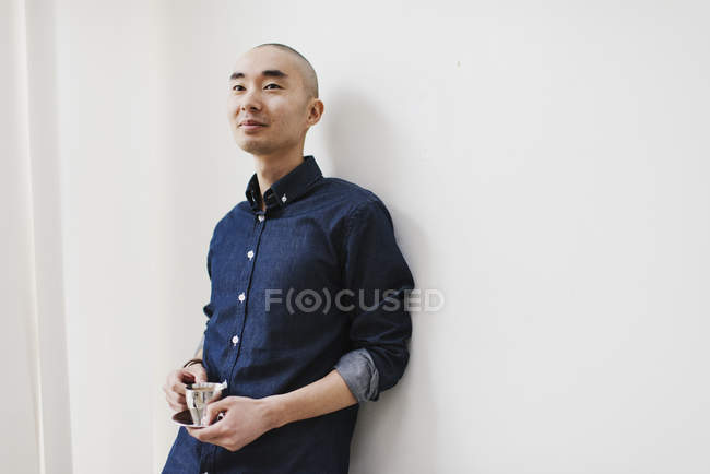 Young man leaning against wall — Stock Photo