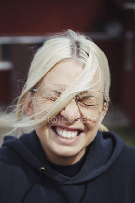 Portrait of grinning woman, focus on foreground — Stock Photo