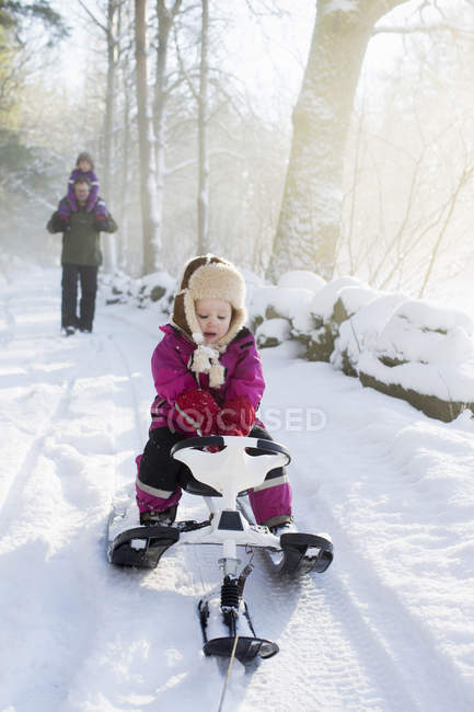 Young girl riding sled, selective focus — Stock Photo