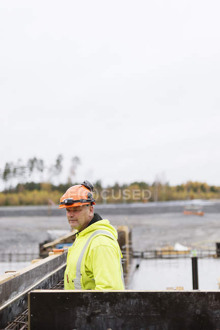 Construction worker looking away at construction site — Stock Photo