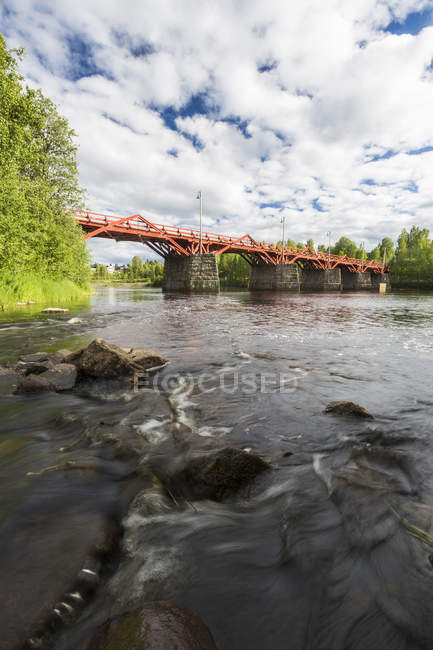 Red bridge over river, Vasterbotten County — Stock Photo