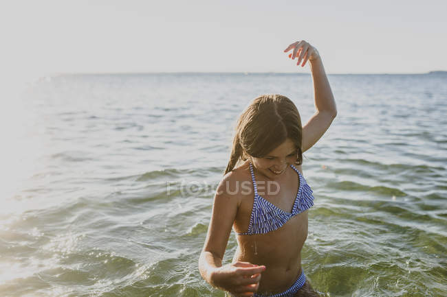 Молода дівчина плаває в морі, фокус на передньому плані — стокове фото