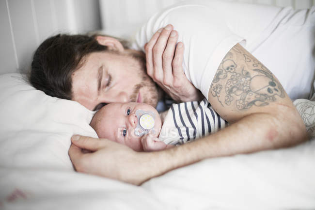 Father and baby boy resting, focus on foreground — Stock Photo