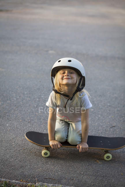 Portrait of girl on skateboard, selective focus — Stock Photo
