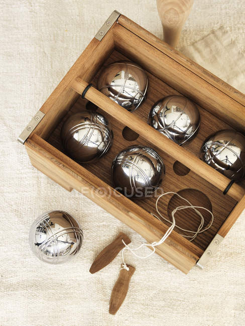 Elevated view of petanque set in wooden container — Stock Photo