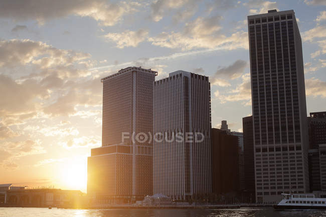 Modern buildings against cloudy sunrise sky — Stock Photo