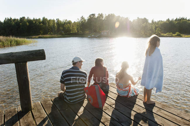 Rear view of family with two children on pier — Stock Photo