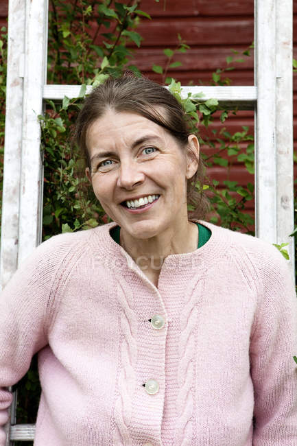 Portrait of mature woman in pink cardigan — Stock Photo