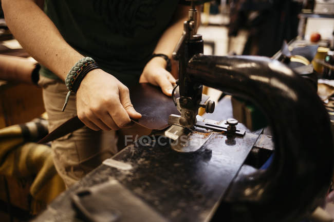 Cropped view of man sewing leather — Stock Photo