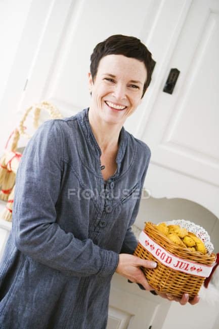 Mature woman holding basket with saffronsaffron — Stock Photo