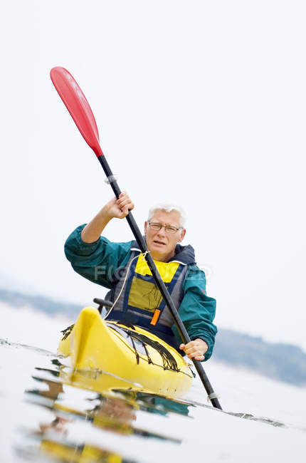 Senior man paddling kayak, selective focus — Stock Photo