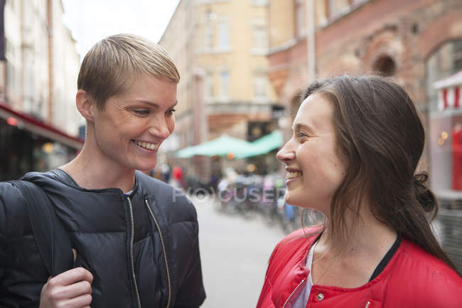Two women standing face to face, focus on foreground — Stock Photo