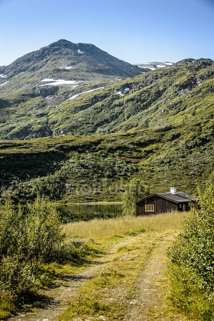 Wooden hut at foot of mountains, Breheimen National Park — Stock Photo