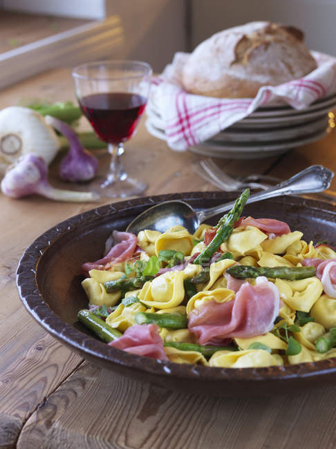 Close-up of tortellini with asparagus and parma ham — Stock Photo