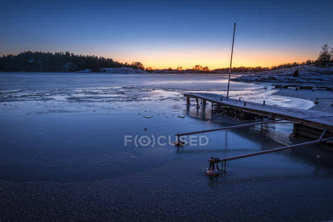 Winter scene with seashore at sunset, northern europe — Stock Photo