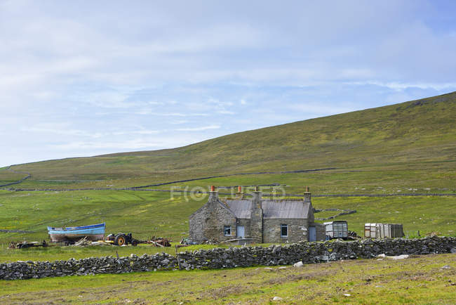 Old stone hut in green field at western europe — Stock Photo