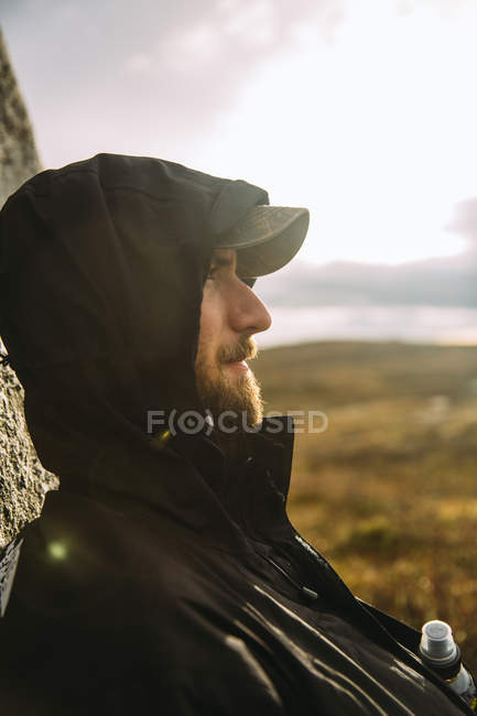 Portrait of young man in baseball cap, focus on foreground — Stock Photo