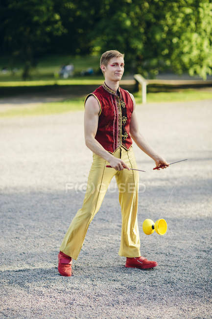 Male street circus performer in park — Stock Photo