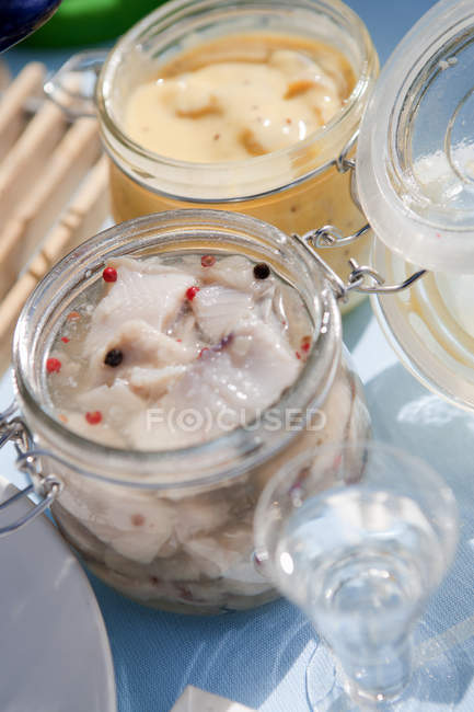 Marinated herring in jars, selective focus — Stock Photo
