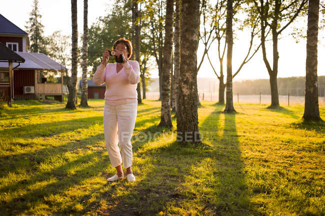 Senior woman taking photo, selective focus — Stock Photo