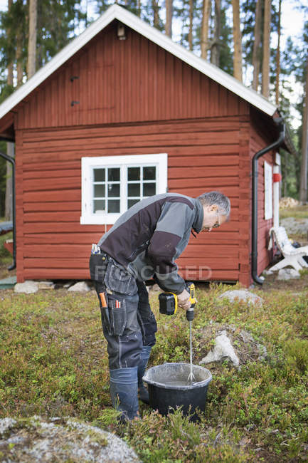 Side view of man mixing concrete — Stock Photo