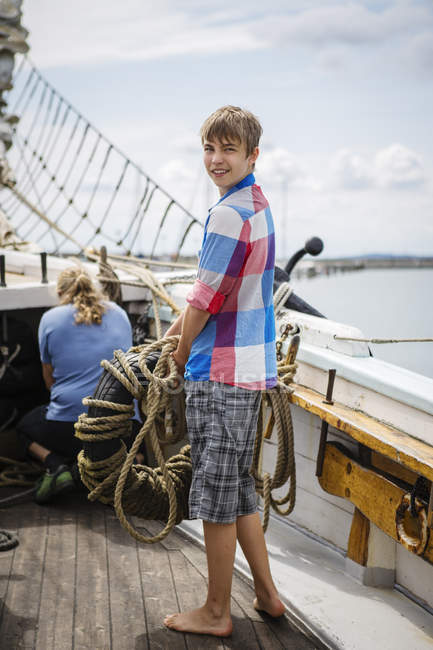 Portrait of teenage boy on boat deck — Stock Photo