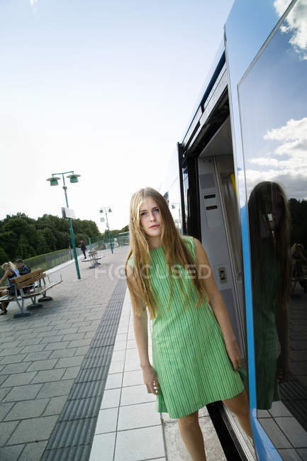 Portrait of teenage girl on railroad station platform — Stock Photo