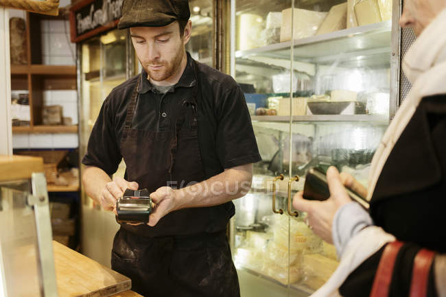 Fishmonger taking payment in store, selective focus — Stock Photo