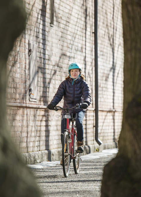 Mid adult woman riding bicycle in Lahti, Finland — Stock Photo
