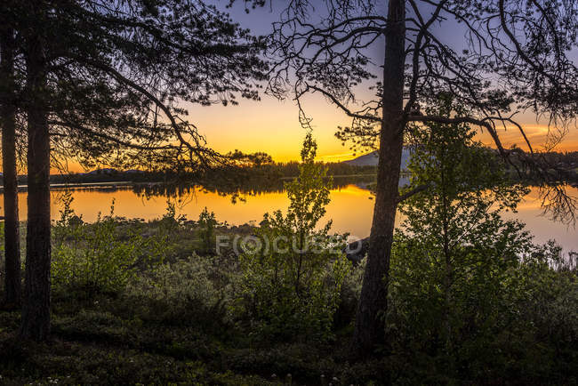 Sol de medianoche sobre el lago en Arjeplog, Suecia - foto de stock