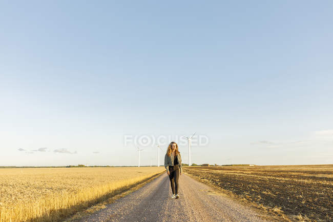 Teenage girl walking on rural road in Vaderstad, Sweden — Stock Photo