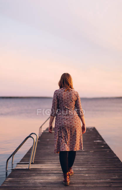 Rear view of woman on pier at beach in Blekinge, Sweden — Stock Photo