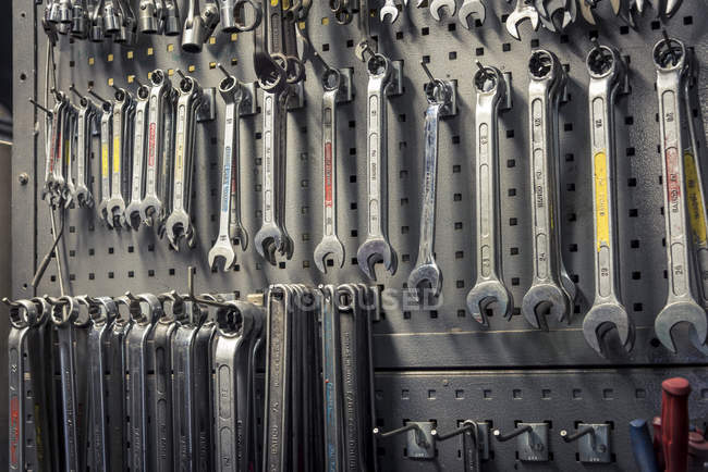 Spanners hanging on hooks, selective focus — Stock Photo