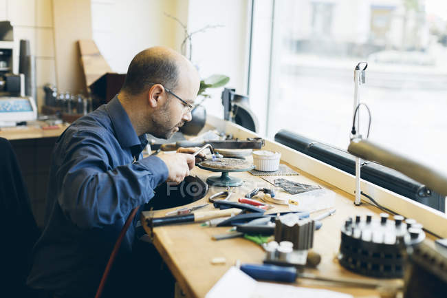 Goldsmith working with blowtorch at workshop, selective focus — Stock Photo
